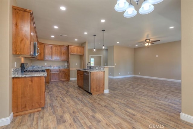 1910 Crandall Way, Paradise, CA 95969 - kitchen with brown cabinets, wood finished floors, pendant lighting, stainless steel appliances, and recessed lighting