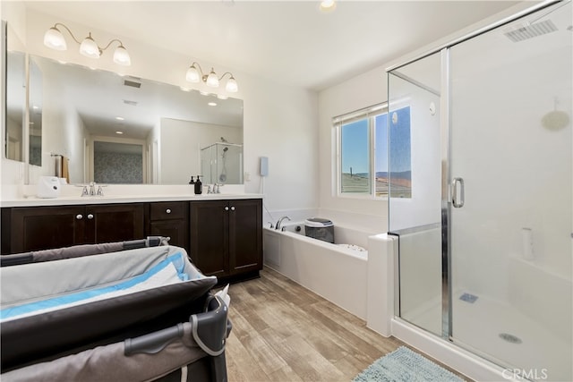 24329 Red Spruce Ave, Murrieta, CA 92562 - full bath with a stall shower, a garden tub, wood finished floors, and double vanity