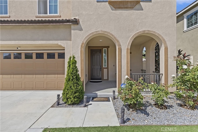 24329 Red Spruce Ave, Murrieta, CA 92562 - entrance to property with stucco siding, a garage, concrete driveway, and covered porch
