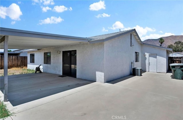 444 Westminister Dr, San Jacinto, CA 92583 - back of property featuring stucco siding and a carport