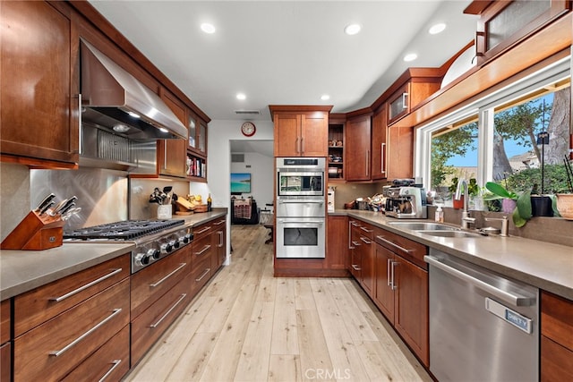 28536 Paseo Diana, San Juan Capistrano, CA 92675 - kitchen featuring appliances with stainless steel finishes, extractor fan, light wood finished floors, recessed lighting, and glass insert cabinets