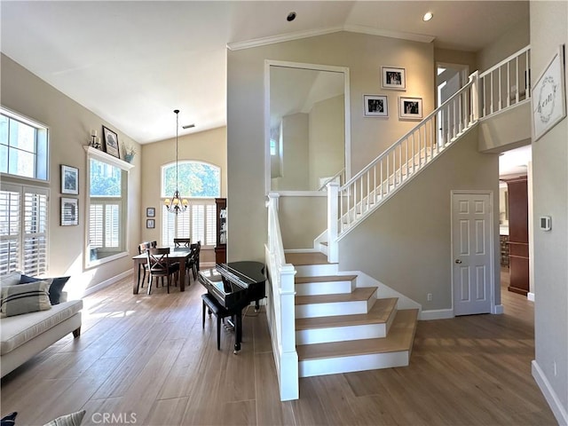 27448 Bridgewater Dr, Valencia, CA 91354 - stairs featuring wood finished floors, high vaulted ceiling, a chandelier, and recessed lighting