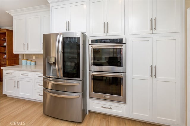 27448 Bridgewater Dr, Valencia, CA 91354 - kitchen featuring stainless steel appliances, light wood finished floors, and white cabinets