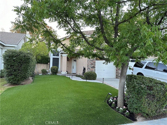 27448 Bridgewater Dr, Valencia, CA 91354 - obstructed view of property featuring a garage, stucco siding, and a front yard