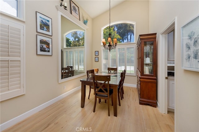 27448 Bridgewater Dr, Valencia, CA 91354 - dining space featuring a chandelier, a towering ceiling, and light wood finished floors