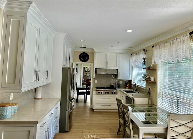 27448 Bridgewater Dr, Valencia, CA 91354 - kitchen featuring freestanding refrigerator, under cabinet range hood, light wood finished floors, stovetop, and white cabinets