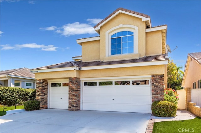 27448 Bridgewater Dr, Valencia, CA 91354 - view of front of home with stucco siding, concrete driveway, and a garage