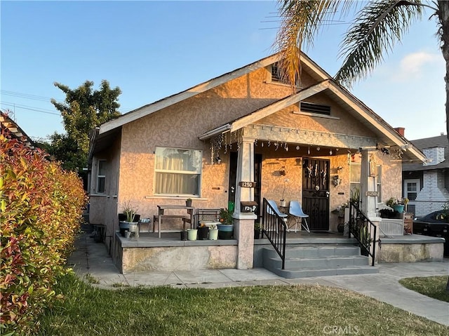 1248 Rolland Curtis Pl, Los Angeles, CA 90037 - view of front of house featuring stucco siding and covered porch