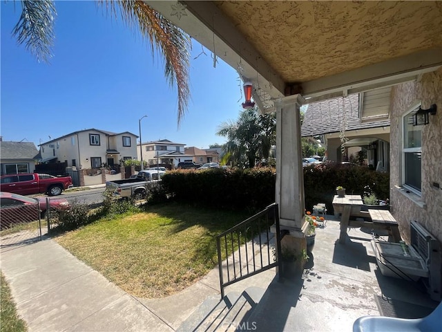 1248 Rolland Curtis Pl, Los Angeles, CA 90037 - covered porch featuring a residential view and a yard