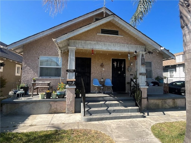 1248 Rolland Curtis Pl, Los Angeles, CA 90037 - view of front of home with covered porch and stucco siding