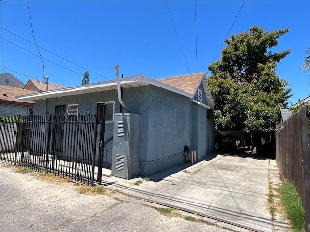 1248 Rolland Curtis Pl, Los Angeles, CA 90037 - view of front facade with stucco siding and a patio