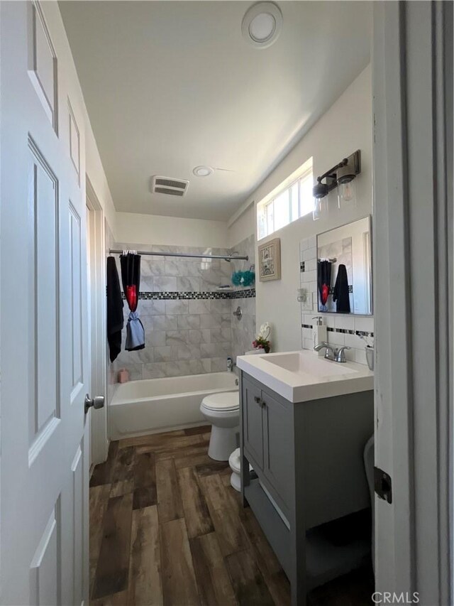 1248 Rolland Curtis Pl, Los Angeles, CA 90037 - bathroom with vanity, wood finished floors, and bathtub / shower combination