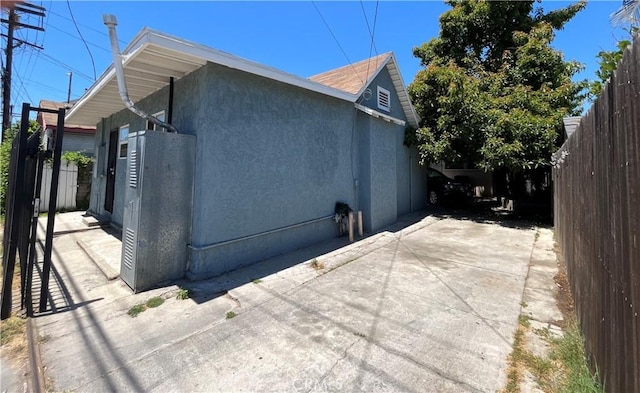 1248 Rolland Curtis Pl, Los Angeles, CA 90037 - view of property exterior featuring stucco siding and a patio