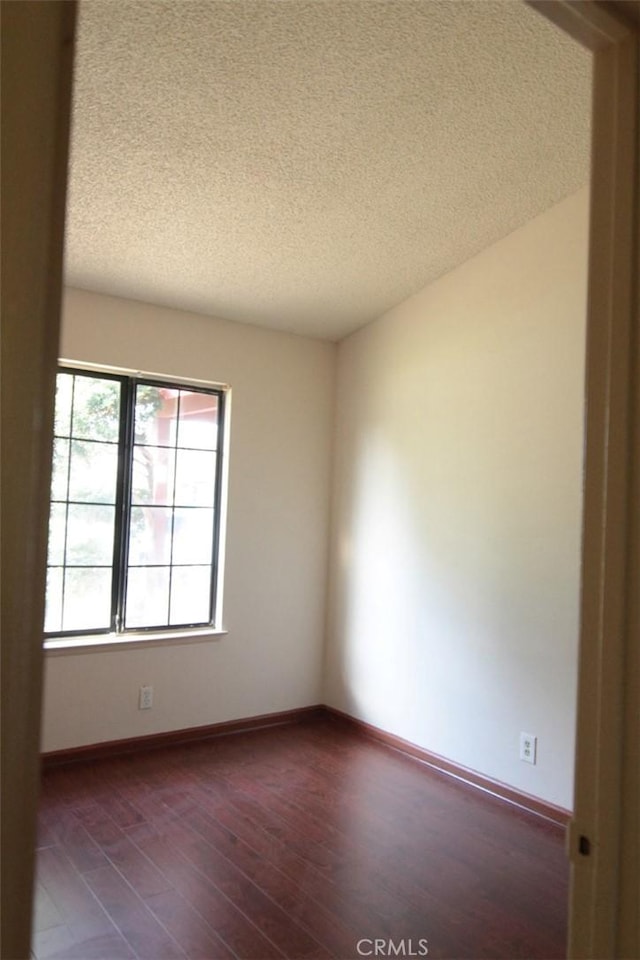 18065 Dorsey Way, Fontana, CA 92335 - empty room with a textured ceiling and dark wood-type flooring
