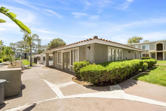 1240 N Broadway Unit 30, Escondido, CA 92026 - view of home's exterior featuring stucco siding and a tiled roof