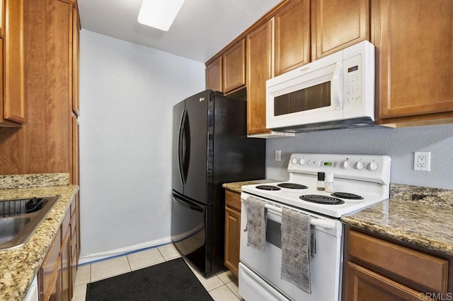 1240 N Broadway Unit 30, Escondido, CA 92026 - kitchen featuring white appliances, light tile patterned floors, brown cabinets, and stone countertops