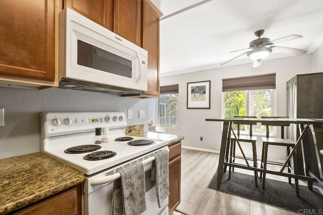 1240 N Broadway Unit 30, Escondido, CA 92026 - kitchen featuring white appliances, brown cabinets, ceiling fan, light wood-style flooring, and ornamental molding
