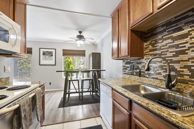 1240 N Broadway Unit 30, Escondido, CA 92026 - kitchen with white appliances, ornamental molding, decorative backsplash, ceiling fan, and light stone counters