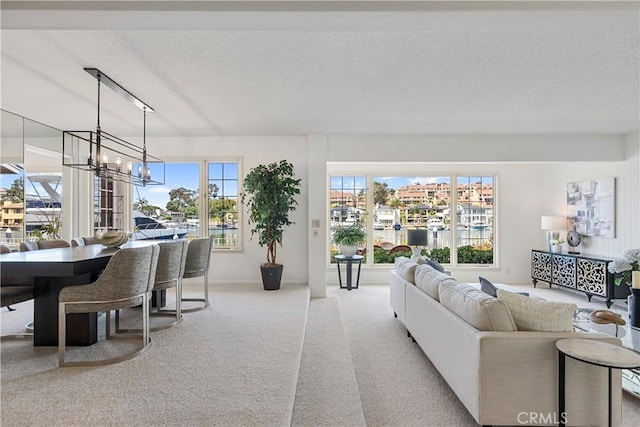 612 Harbor Island Dr, Newport Beach, CA 92660 - living area featuring carpet, a textured ceiling, and a chandelier