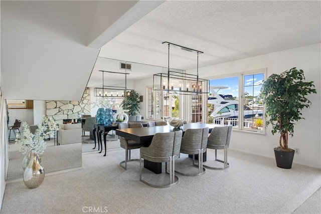 612 Harbor Island Dr, Newport Beach, CA 92660 - dining room featuring a chandelier, carpet floors, a textured ceiling, and a fireplace