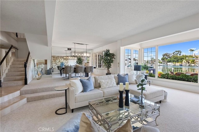 612 Harbor Island Dr, Newport Beach, CA 92660 - living room with carpet flooring, a textured ceiling, stairway, a chandelier, and a water view