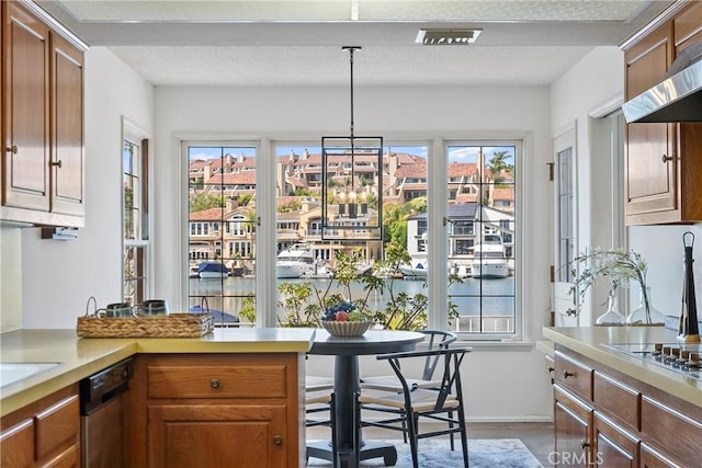 612 Harbor Island Dr, Newport Beach, CA 92660 - kitchen featuring wall chimney range hood, light countertops, and healthy amount of natural light