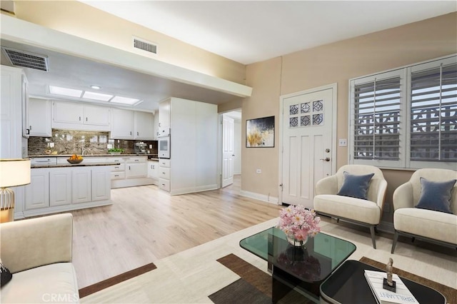 13300 Twin Hills Dr Unit 46A, Seal Beach, CA 90720 - living room featuring light wood-type flooring and baseboards