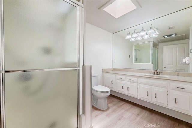 13300 Twin Hills Dr Unit 46A, Seal Beach, CA 90720 - full bath with vanity, a stall shower, a skylight, and wood finished floors