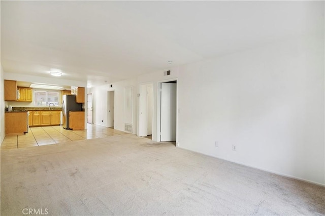 1745 Los Feliz Dr Unit 2, Thousand Oaks, CA 91362 - unfurnished living room with light colored carpet and light tile patterned floors