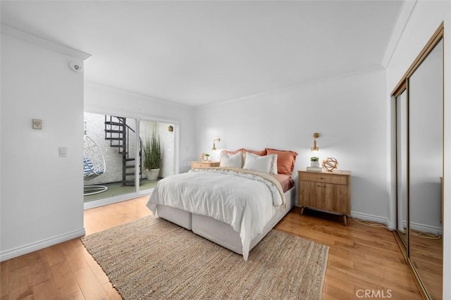 1200 Opal St Unit 7, Redondo Beach, CA 90277 - bedroom featuring access to exterior, ornamental molding, and light wood-style floors
