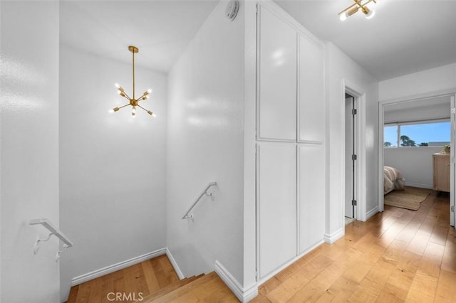 1200 Opal St Unit 7, Redondo Beach, CA 90277 - corridor featuring an upstairs landing, a chandelier, and light wood-style flooring