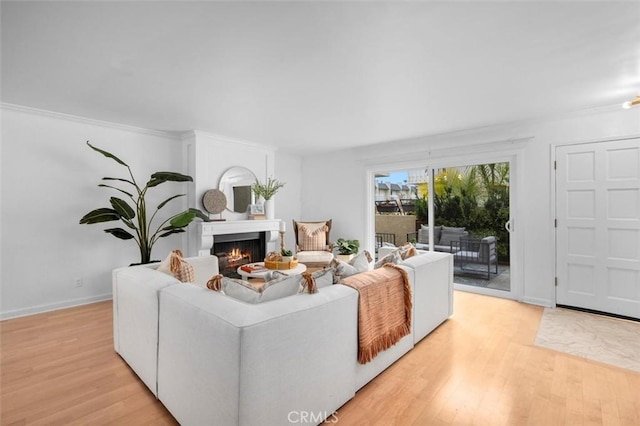 1200 Opal St Unit 7, Redondo Beach, CA 90277 - living room featuring light wood-type flooring, a lit fireplace, and crown molding