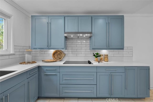 1200 Opal St Unit 7, Redondo Beach, CA 90277 - kitchen featuring black electric cooktop, under cabinet range hood, decorative backsplash, light countertops, and ornamental molding