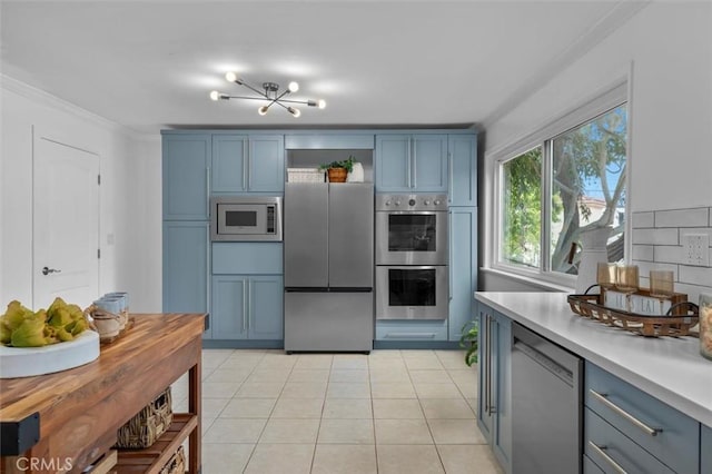 1200 Opal St Unit 7, Redondo Beach, CA 90277 - kitchen with stainless steel appliances, blue cabinets, light countertops, open shelves, and ornamental molding