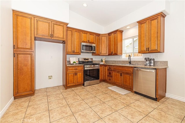 4158 Larchwood Pl, Riverside, CA 92506 - kitchen with appliances with stainless steel finishes, brown cabinetry, light stone countertops, lofted ceiling, and light tile patterned floors