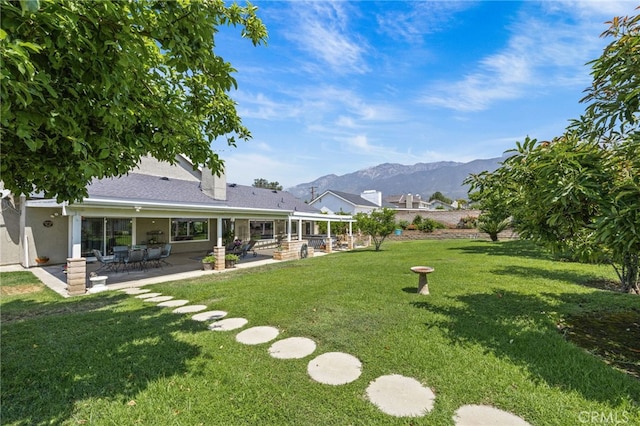 6055 Amethyst Ave, Rancho Cucamonga, CA 91737 - view of grassy yard featuring a mountain view and a patio