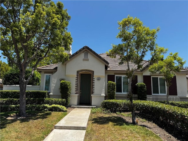 42 Seacountry Ln, Rancho Santa Margarita, CA 92688 - view of front of house featuring stucco siding, a tile roof, and a front yard