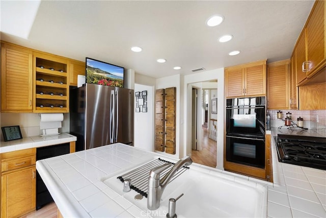46 Saint Tropez, Laguna Niguel, CA 92677 - kitchen featuring black appliances, tile countertops, open shelves, recessed lighting, and backsplash