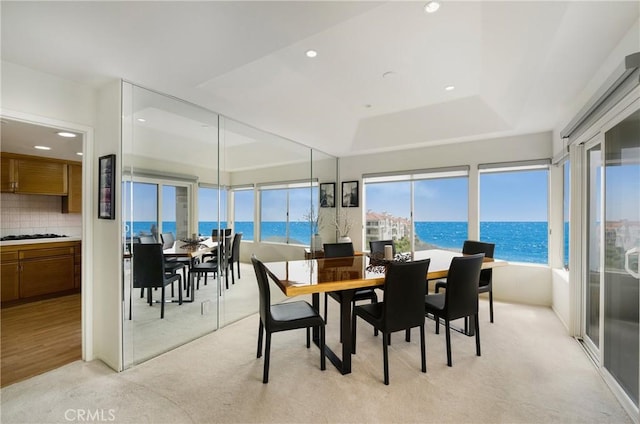46 Saint Tropez, Laguna Niguel, CA 92677 - dining room featuring light carpet, a water view, recessed lighting, and a tray ceiling