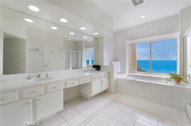 46 Saint Tropez, Laguna Niguel, CA 92677 - full bathroom featuring tile patterned floors, double vanity, a bath, recessed lighting, and a shower stall