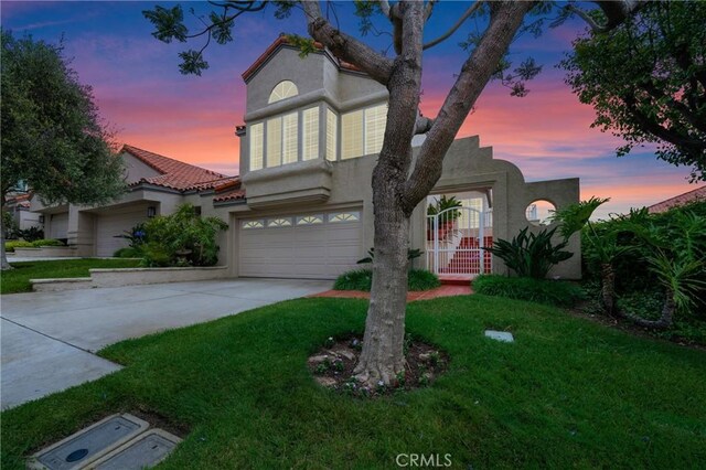 46 Saint Tropez, Laguna Niguel, CA 92677 - view of front of home featuring stucco siding, concrete driveway, an attached garage, and a front yard
