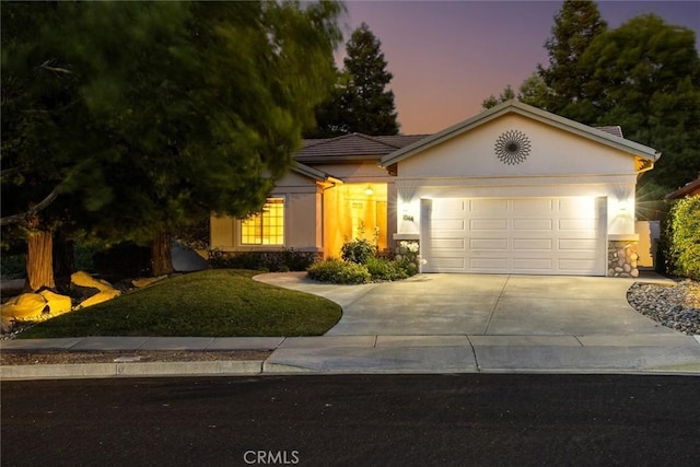 1044 Sleepy Hollow Rd, Paso Robles, CA 93446 - ranch-style home featuring driveway, stucco siding, an attached garage, and stone siding
