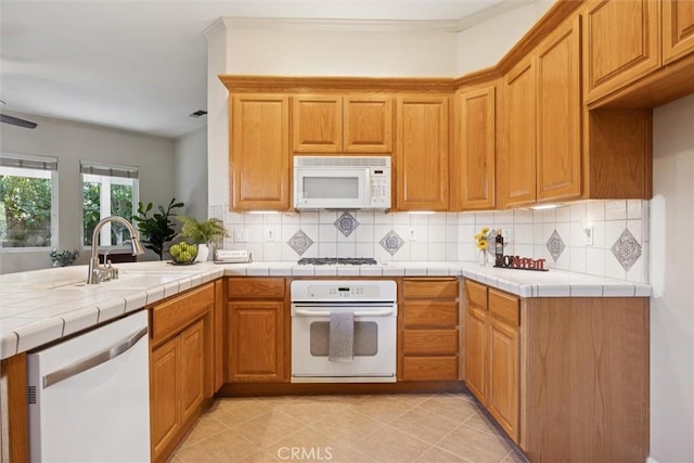 1044 Sleepy Hollow Rd, Paso Robles, CA 93446 - kitchen featuring white appliances, decorative backsplash, a peninsula, and light tile patterned flooring
