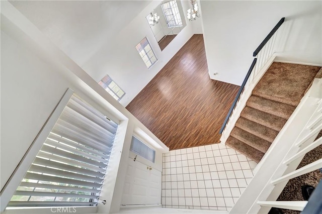 3115 Crowne Dr, Palmdale, CA 93551 - stairs featuring plenty of natural light, a towering ceiling, and wood finished floors