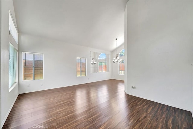 3115 Crowne Dr, Palmdale, CA 93551 - empty room featuring a chandelier, dark wood finished floors, and high vaulted ceiling