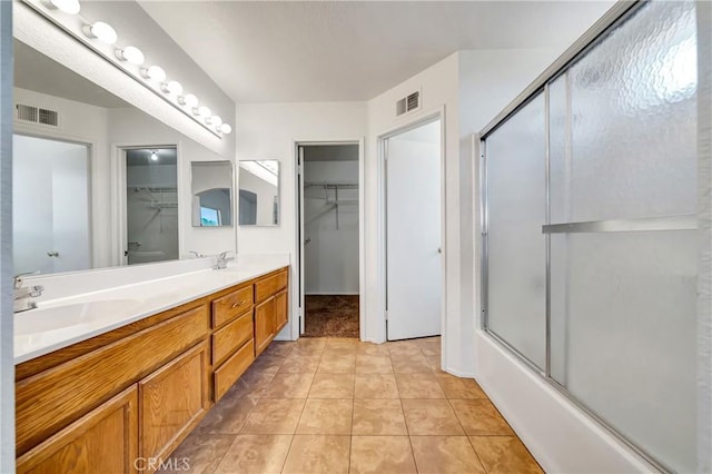 3115 Crowne Dr, Palmdale, CA 93551 - bathroom with double vanity, a walk in closet, shower / bath combination with glass door, and tile patterned floors