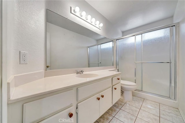 3115 Crowne Dr, Palmdale, CA 93551 - full bath with vanity, tile patterned floors, a shower with shower door, and a textured wall