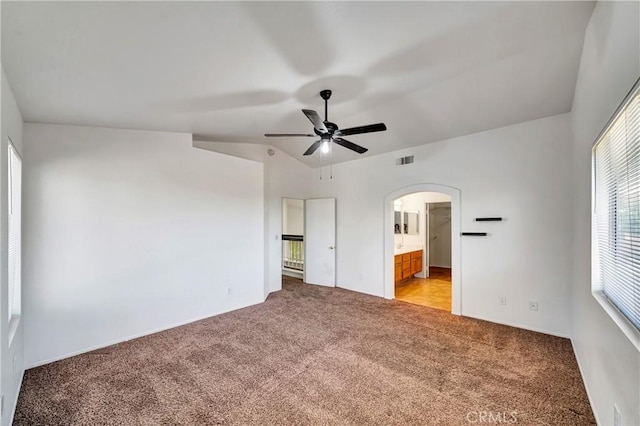 3115 Crowne Dr, Palmdale, CA 93551 - unfurnished bedroom with light colored carpet, arched walkways, ensuite bathroom, and a ceiling fan