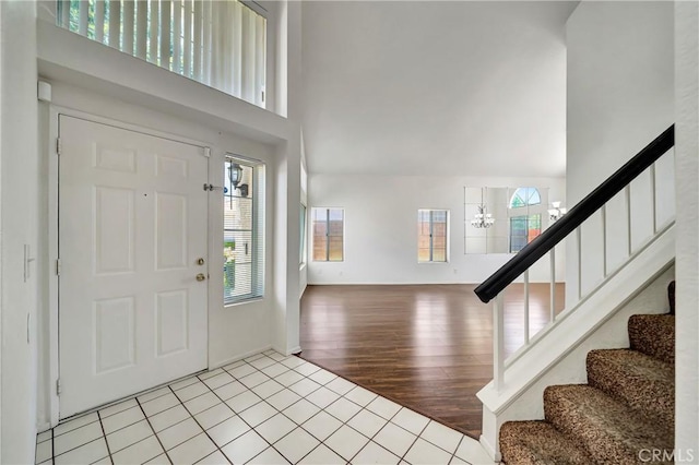 3115 Crowne Dr, Palmdale, CA 93551 - tiled entrance foyer featuring a towering ceiling, healthy amount of natural light, stairway, and a chandelier