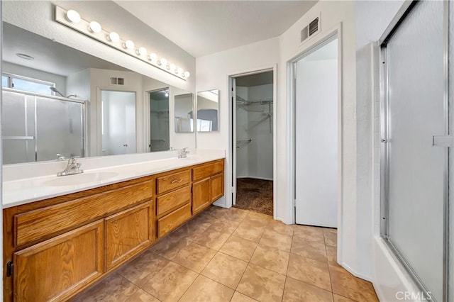 3115 Crowne Dr, Palmdale, CA 93551 - full bathroom featuring double vanity, a walk in closet, and tile patterned floors